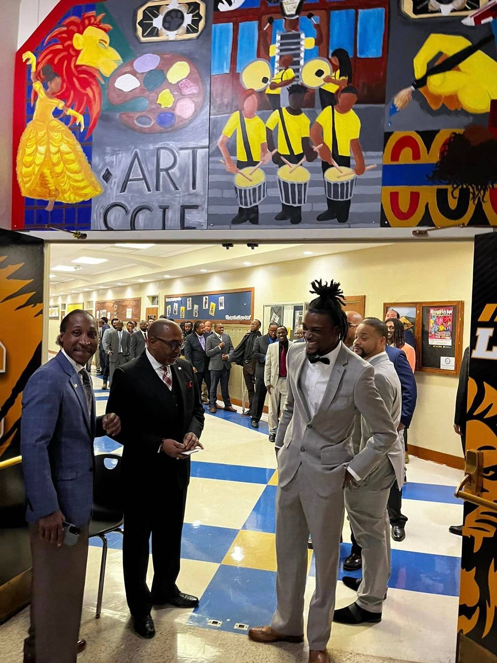 Men waiting to process into the University City High School auditorium for the 159th Family Formation graduation.