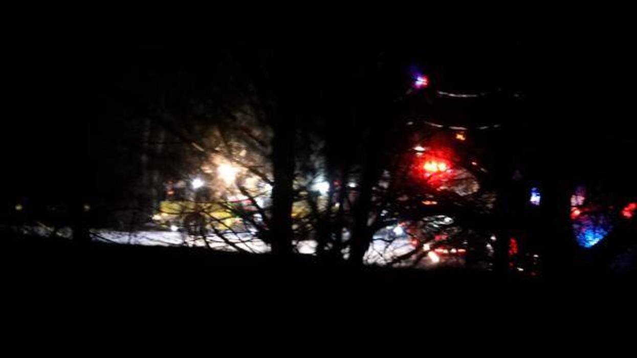 Mendon firefighters and other emergency personnel respond to a military helicopter crash in a field near Cheese Factory Road and W. Bloomfield Road in Mendon, N.Y., late Wednesday, Jan. 20, 2021. Three National Guard members on the routine training flight were killed, according to authorities. (Tina MacIntyre-Yee/Democrat & Chronicle via AP)