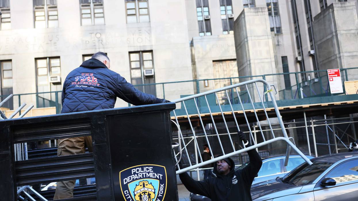 Metal barricades are unloaded in front of Manhattan Criminal Court on March 20, 2023