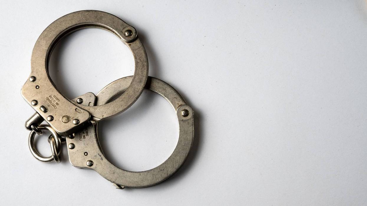 Metal handcuffs and white background