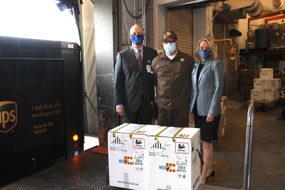 Methodist Health System CEO Jim Scoggin and President and COO Pam Stoyanoff pictured with UPS delivery man