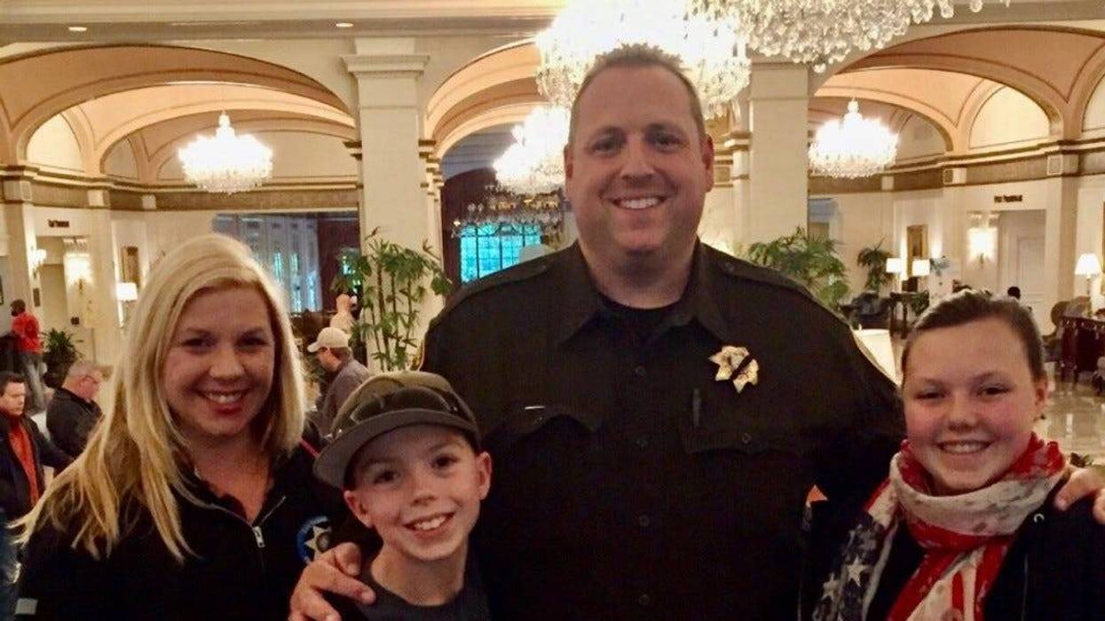 Metro Police officer Phil Closi poses with his wife and two kids