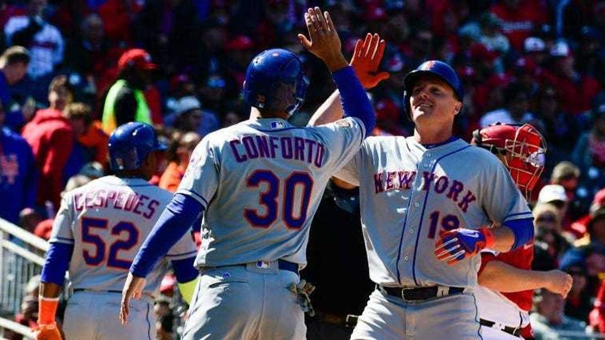 Mets right fielder Jay Bruce (19) high-fives Michael Conforto after hitting a grand slam against the Washington Nationals on April 5, 2018, at Nationals Park in Washington, D.C.