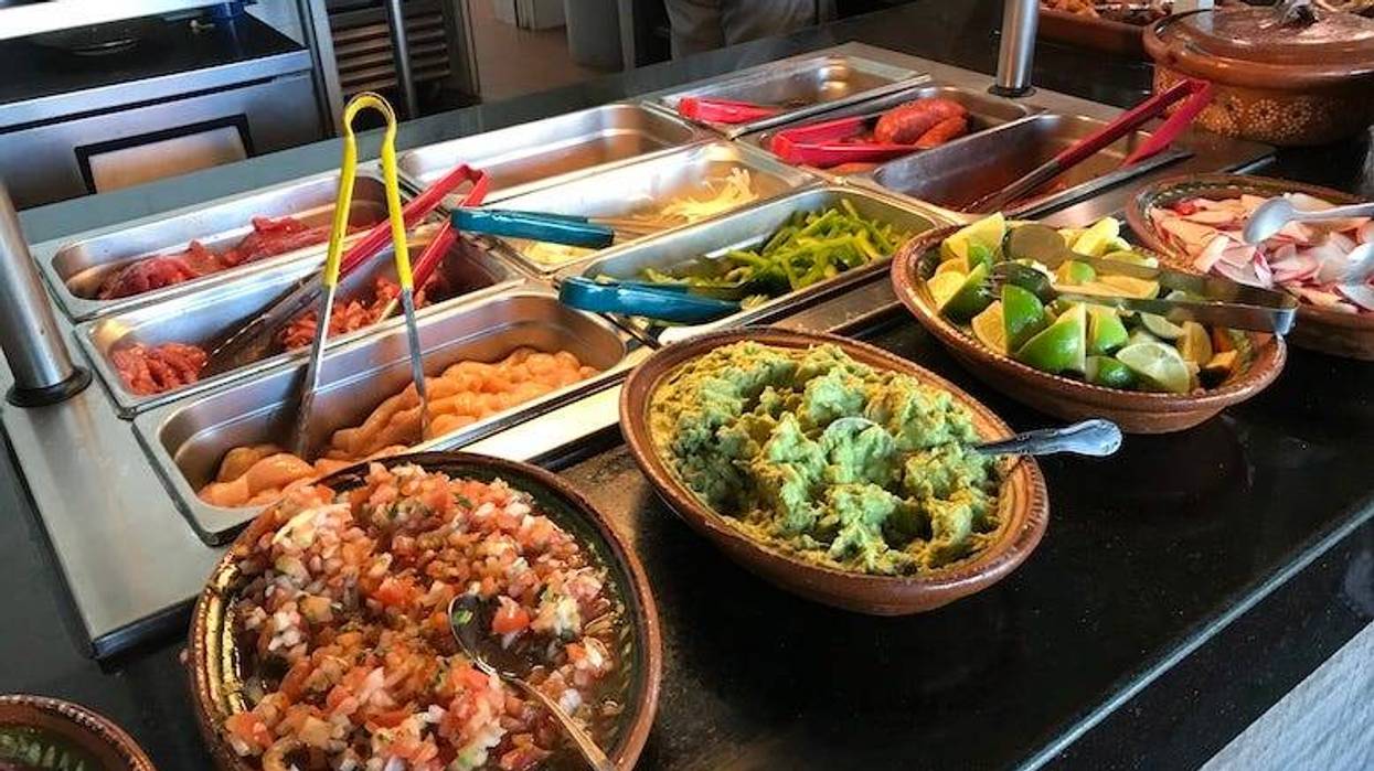 Mexican food on display in a buffet line