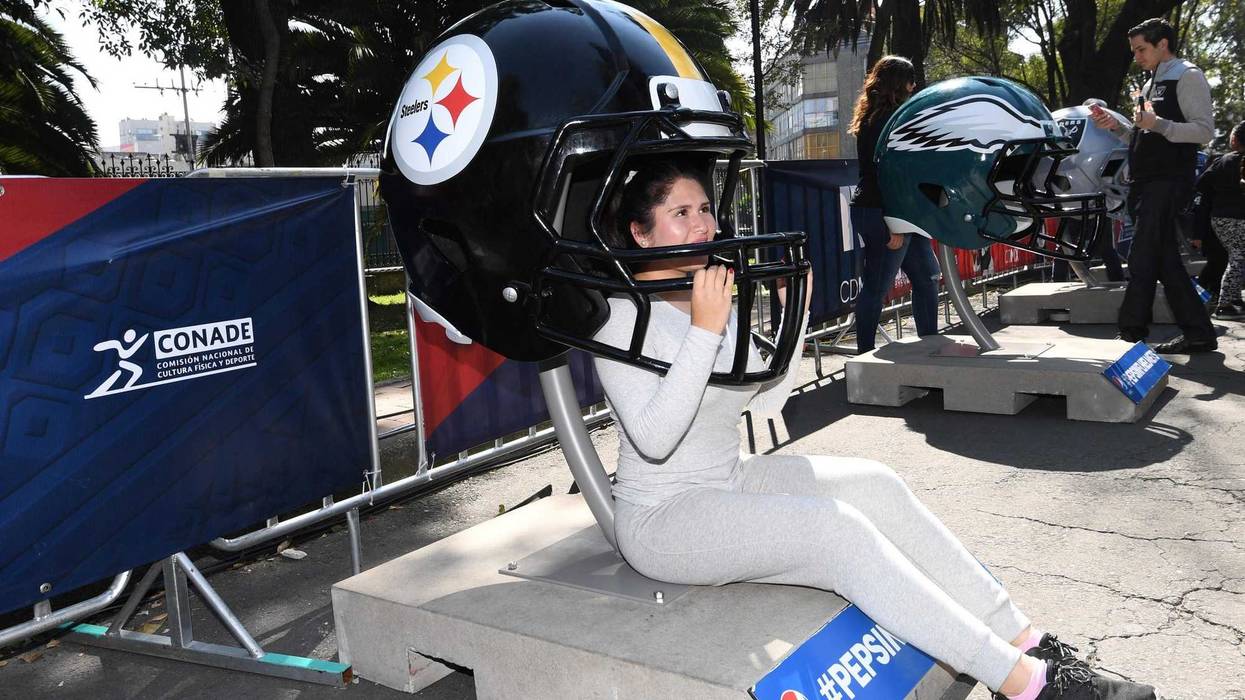 Mexico City, MEX; Female fan poses with replica Pittsburgh Steelers helmet during the NFL Fan Fest