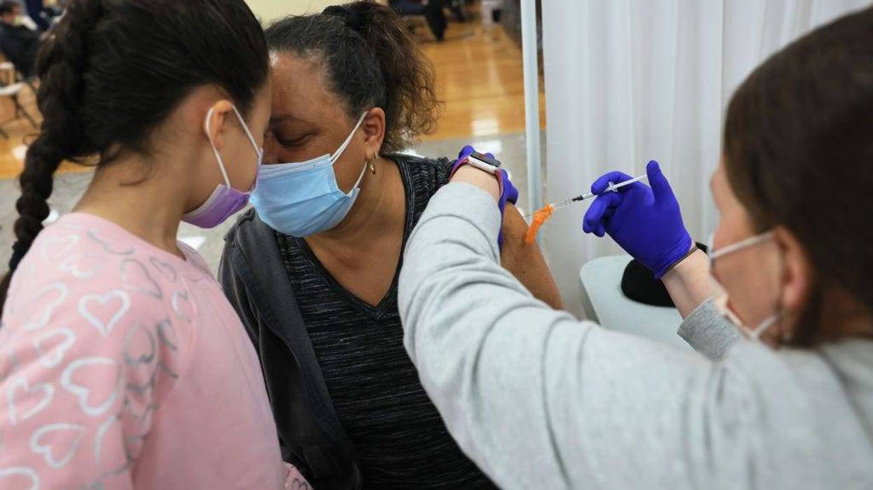 Mia Rosado, 8, rests her head on her grandmother Jacquline Flynn as she is administered the Johnson & Johnson coronavirus (COVID-19) at the Northwell Health pop-up coronavirus (COVID-19) vaccination site at the Albanian Islamic Cultural Center in Staten Island on April 08, 2021 in New York City. NYC continues to have a 6.55 percent coronavirus (COVID-19) cases on a seven-day rolling average as the city continues to ramp up vaccinations. The city last week set a record of 524,520 coronavirus (COVID-19) vaccinations.