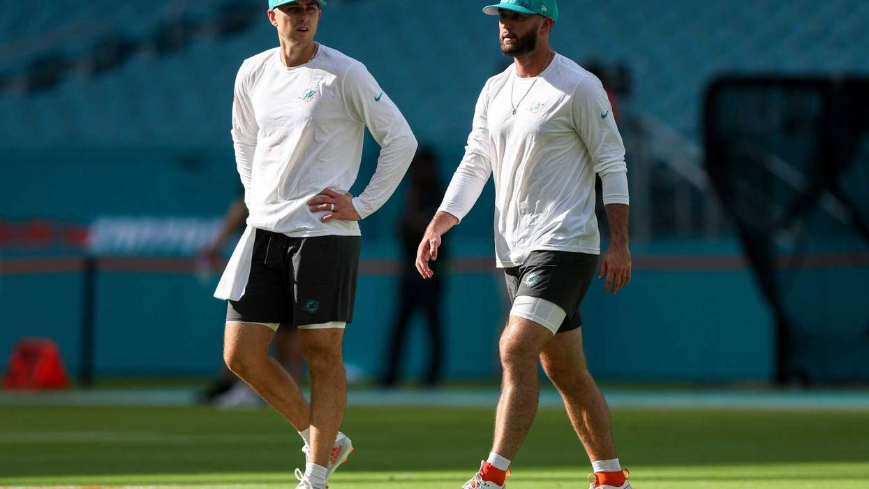 Miami Dolphins quarterback Skylar Thompson (19) and quarterback Mike White (14) warm up before a game against the Atlanta Falcons at Hard Rock Stadium.