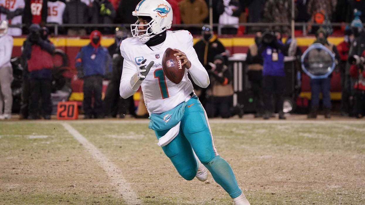 Miami Dolphins quarterback Tua Tagovailoa (1) moves out to pass against the Kansas City Chiefs during the second half of the 2024 AFC wild card game at GEHA Field at Arrowhead Stadium.