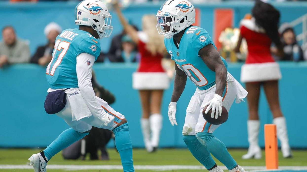 Miami Dolphins wide receiver Tyreek Hill (10) celebrates with wide receiver Jaylen Waddle (17) after catching the football during the second quarter against the Green Bay Packers at Hard Rock Stadium.