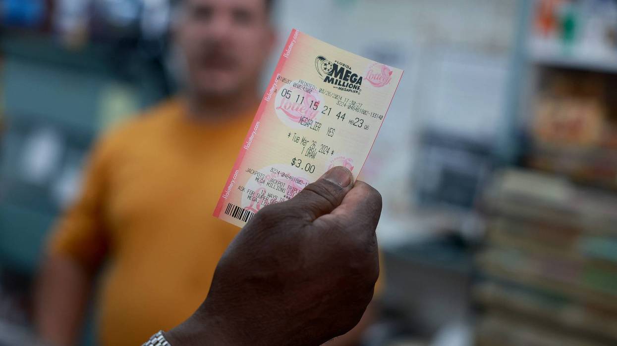MIAMI, FLORIDA - MARCH 26: A customer purchases a Mega Million lottery ticket at the La Esquina Tropical supermarket on March 26, 2024 in Miami, Florida. The Mega Millions jackpot has reached $1.13 billion for tonight's drawing.