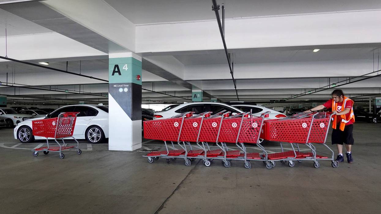 MIAMI, FLORIDA - MAY 18: An employee works on taking carts back to a Target store on May 18, 2022 in Miami, Florida. The retail store reported a 52% drop in profit for the first quarter, missing Wall Street's forecasts. The company blamed higher expenses due to continued supply chain disruptions as well as the high inflation rate.