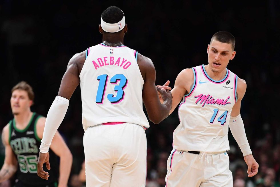 Miami Heat center Bam Adebayo (13) is congratulated by guard Tyler Herro (14) after making a basket during the second half against the Boston Celtics at TD Garden.