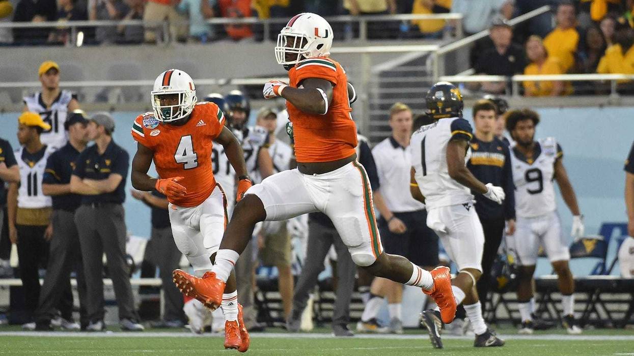 Miami Hurricanes defensive lineman Chad Thomas (9) celebrates after forcing a West Virginia Mountaineers fumble during the first half at Camping World Stadium.