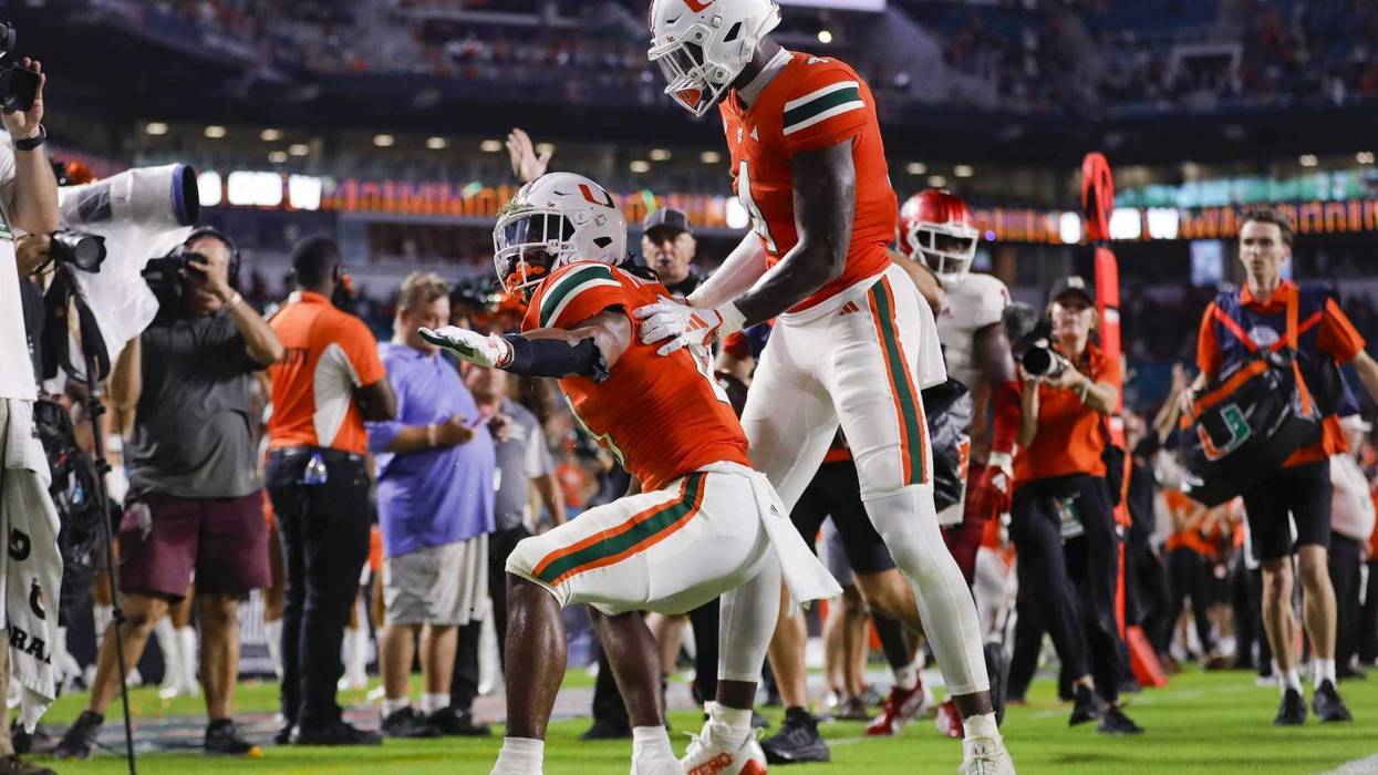 Miami Hurricanes running back Henry Parrish Jr. (21) celebrates with wide receiver Colbie Young (4) after scoring a touchdown against the Miami (OH) Redhawks during the fourth quarter at Hard Rock Stadium