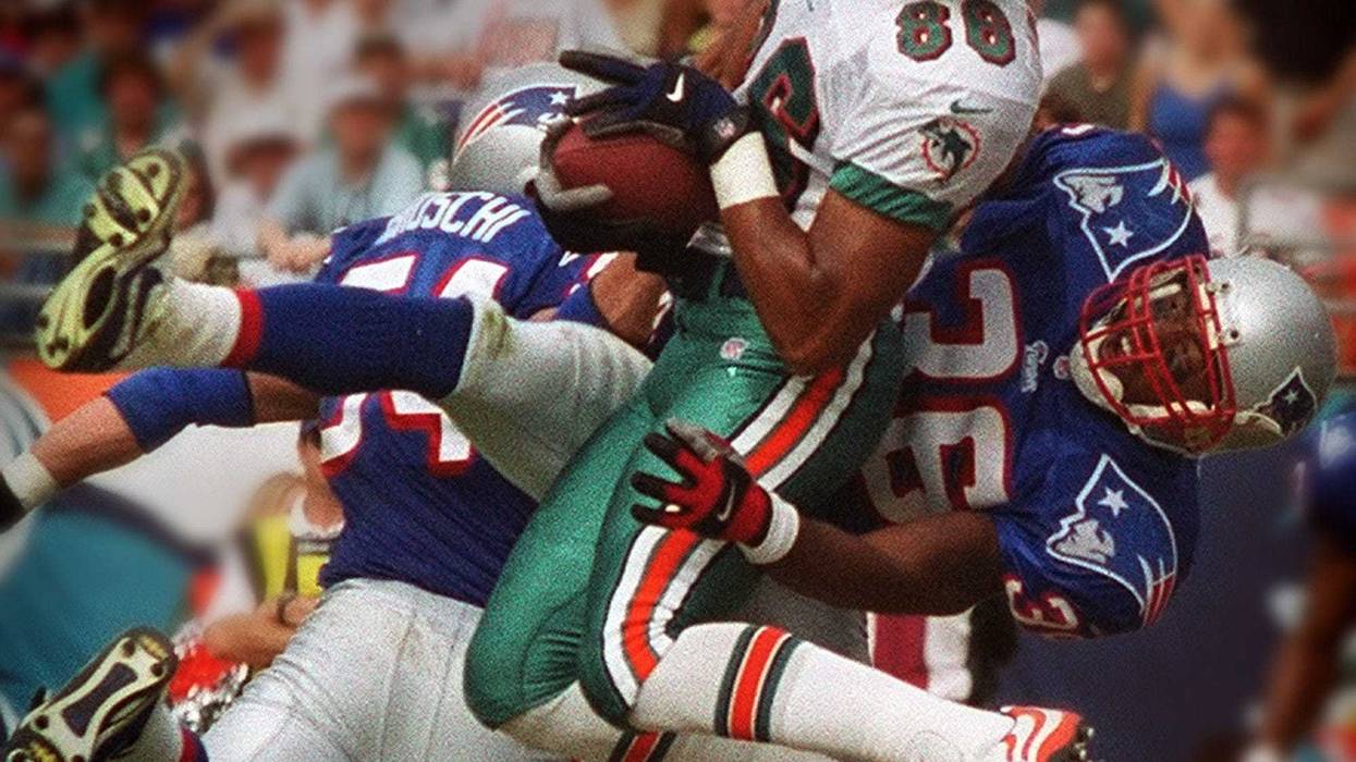 Miami's Oronde Gadsden hangs on to the ball for a touchdown