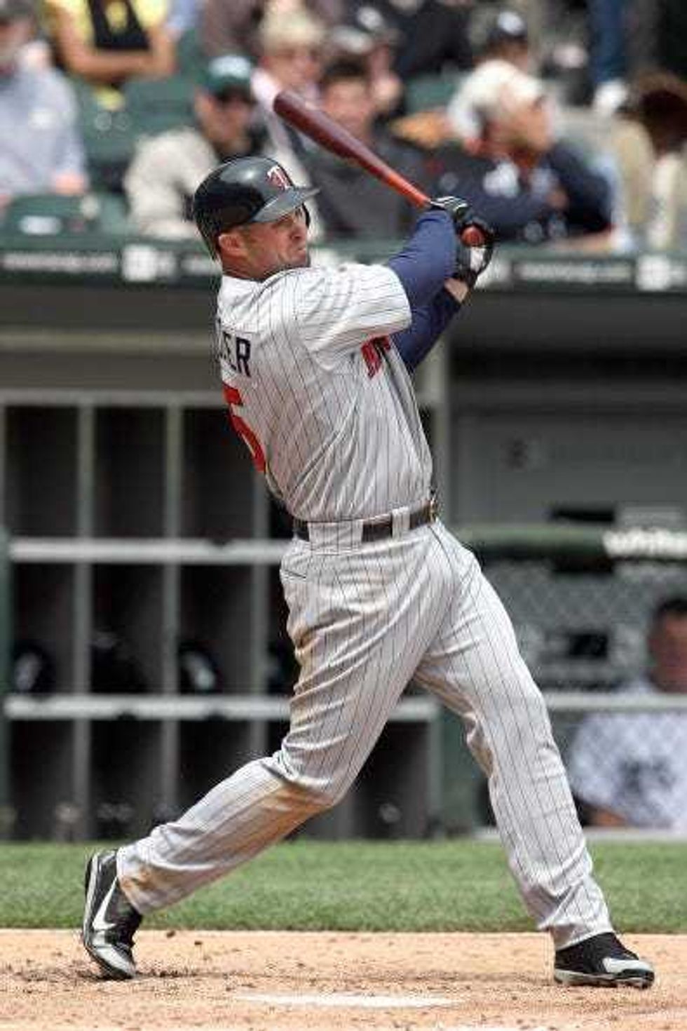 Michael Cuddyer #5 of the Minnesota Twins swings at a pitch during the game against the Chicago White Sox on May 8, 2008 at U.S. Cellular Field in Chicago, Illinois.