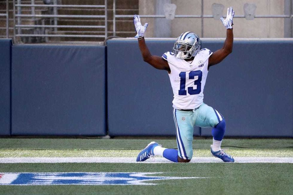 Michael Gallup celebrates after scoring a touchdown.