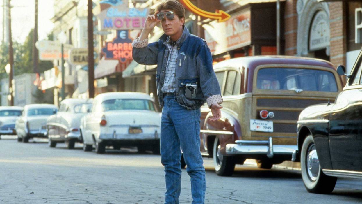 Michael J Fox walking across the street in a scene from the film 'Back To The Future', 1985.