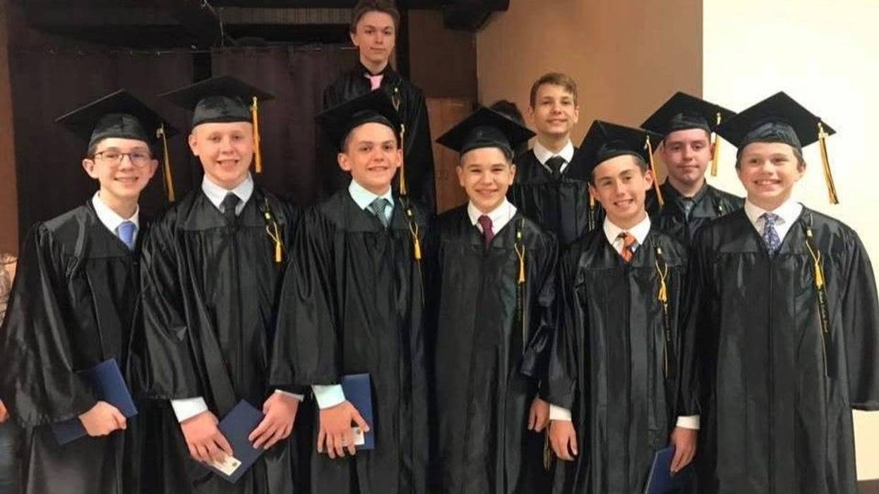 Michael Kennedy with his St. Hubert eighth grade class. Kennedy is leading an effort to save the school, which is set to close at the end of the school year due to declining enrollment.