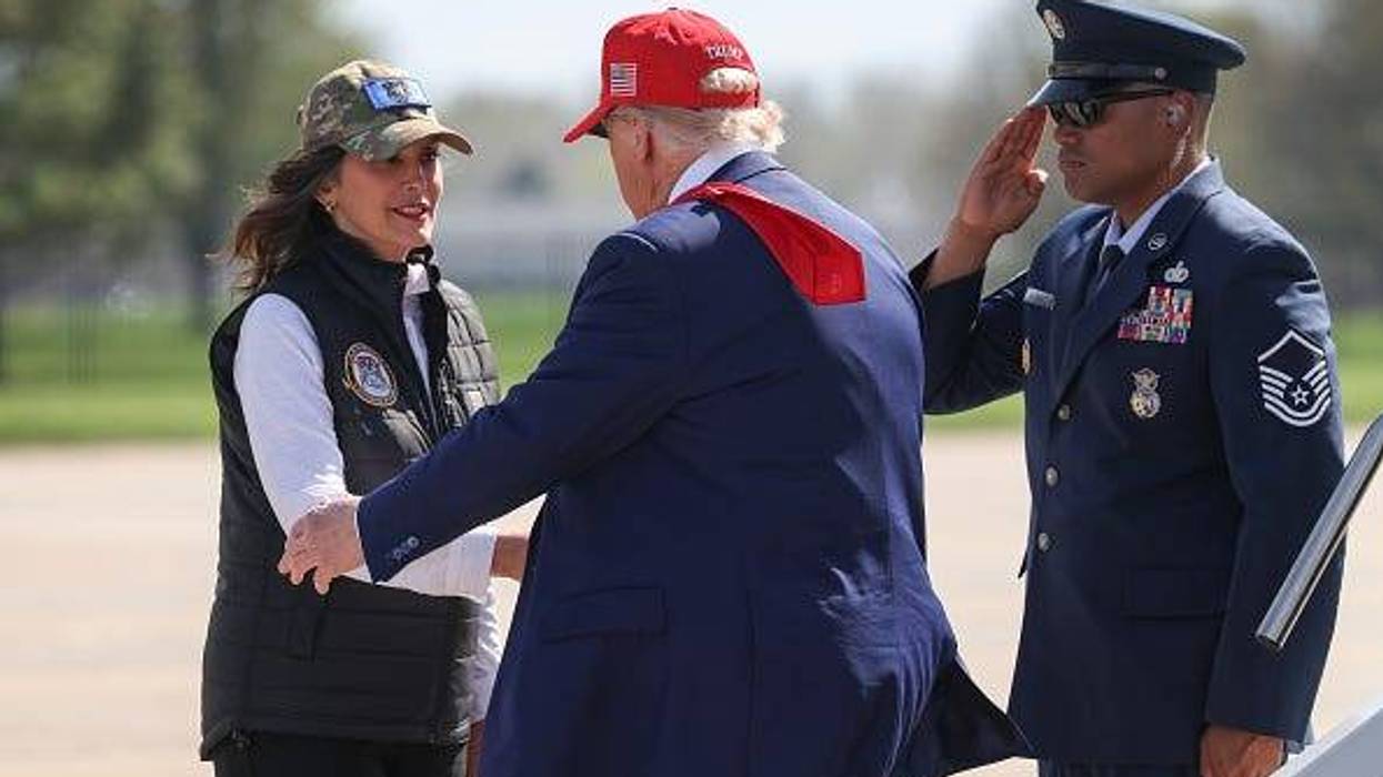 Michigan Gov. Gretchen Whitmer greets President Donald Trump after he arrived on Air Force One to speak to Air National Guard troops on April 29, 2025 at Selfridge Air National Guard Base, Michigan