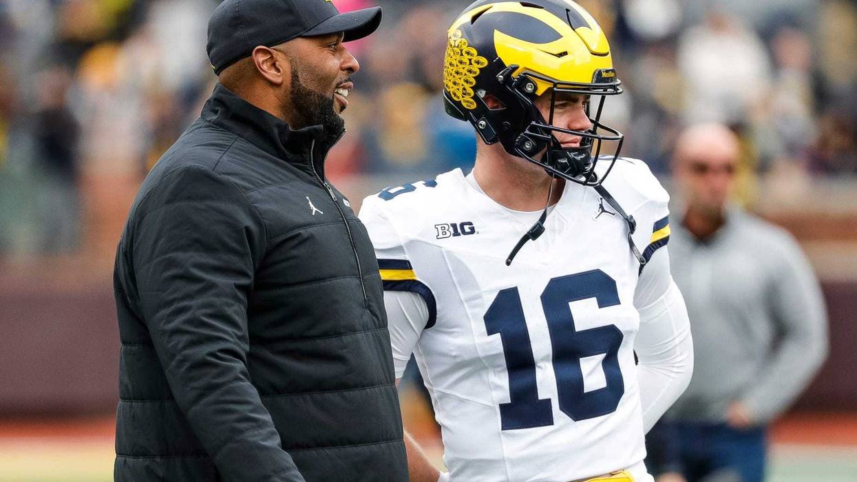 Michigan head coach Sherrone Moore talks to quarterback Davis Warren (16) at warmup during the spring game at Michigan Stadium in Ann Arbor on Saturday, April 20, 2024.
