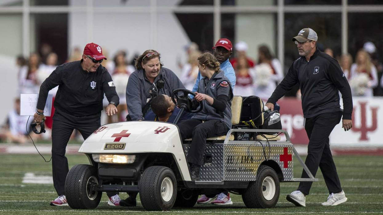 Michigan running game coordinator Mike Hart was carted off the field on a backboard and taken to a hospital for further evaluation during Saturday's game at Indiana.