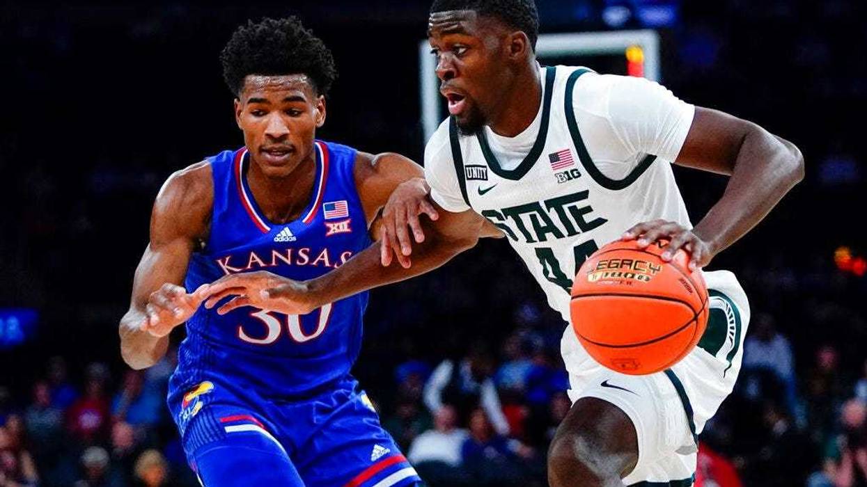 Michigan State's Gabe Brown (44) drives past Kansas' Ochai Agbaji (30)