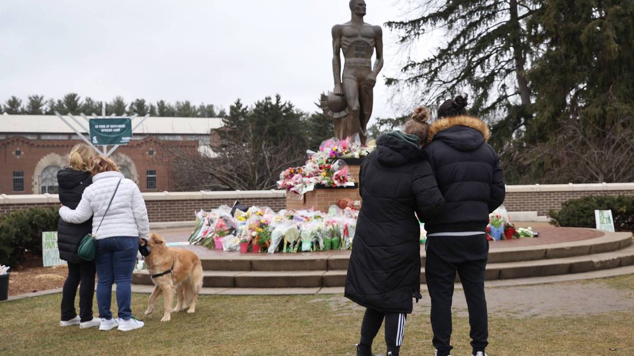 Michigan State University students reflect at Spartan Statue the day after deadly shooting in 2023.