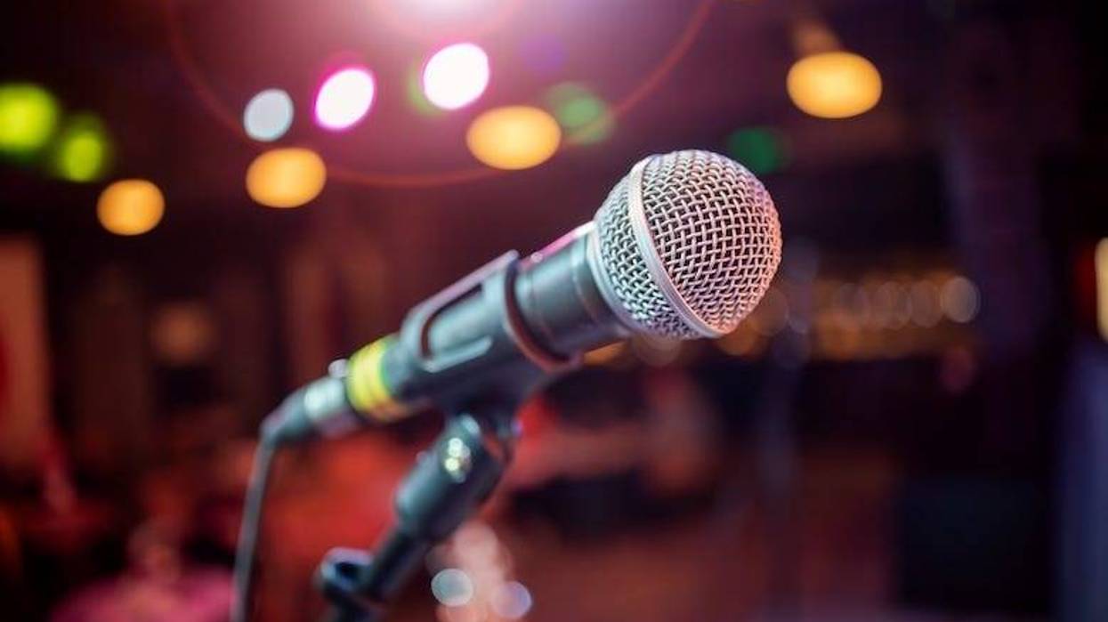 Microphone on stage against a background of auditorium.