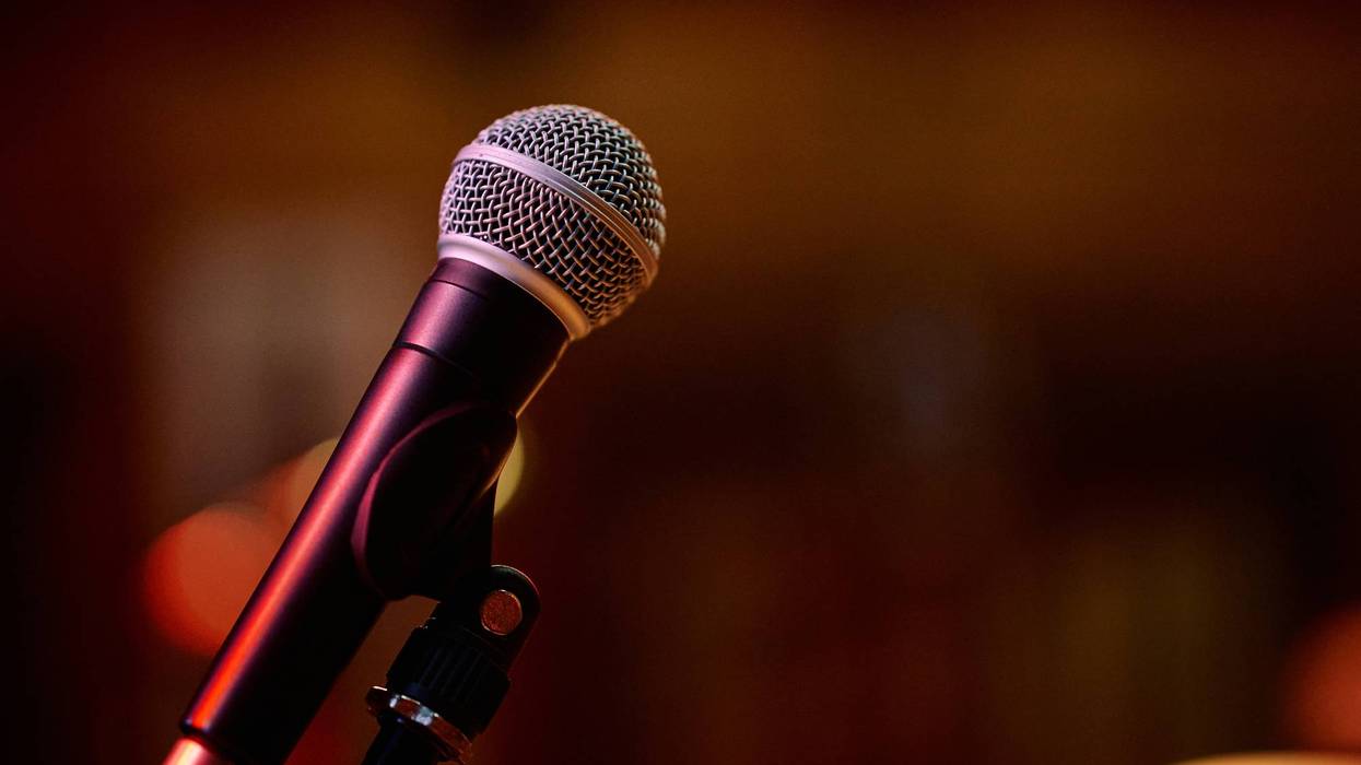 Microphone ready for a heavy metal concert with energetic crowd in background