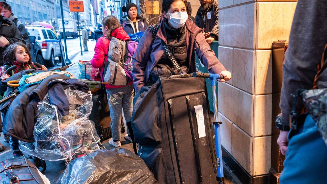 Migrants and their families check into a processing center at the Roosevelt Hotel in Midtown Manhattan on Jan. 9, 2024