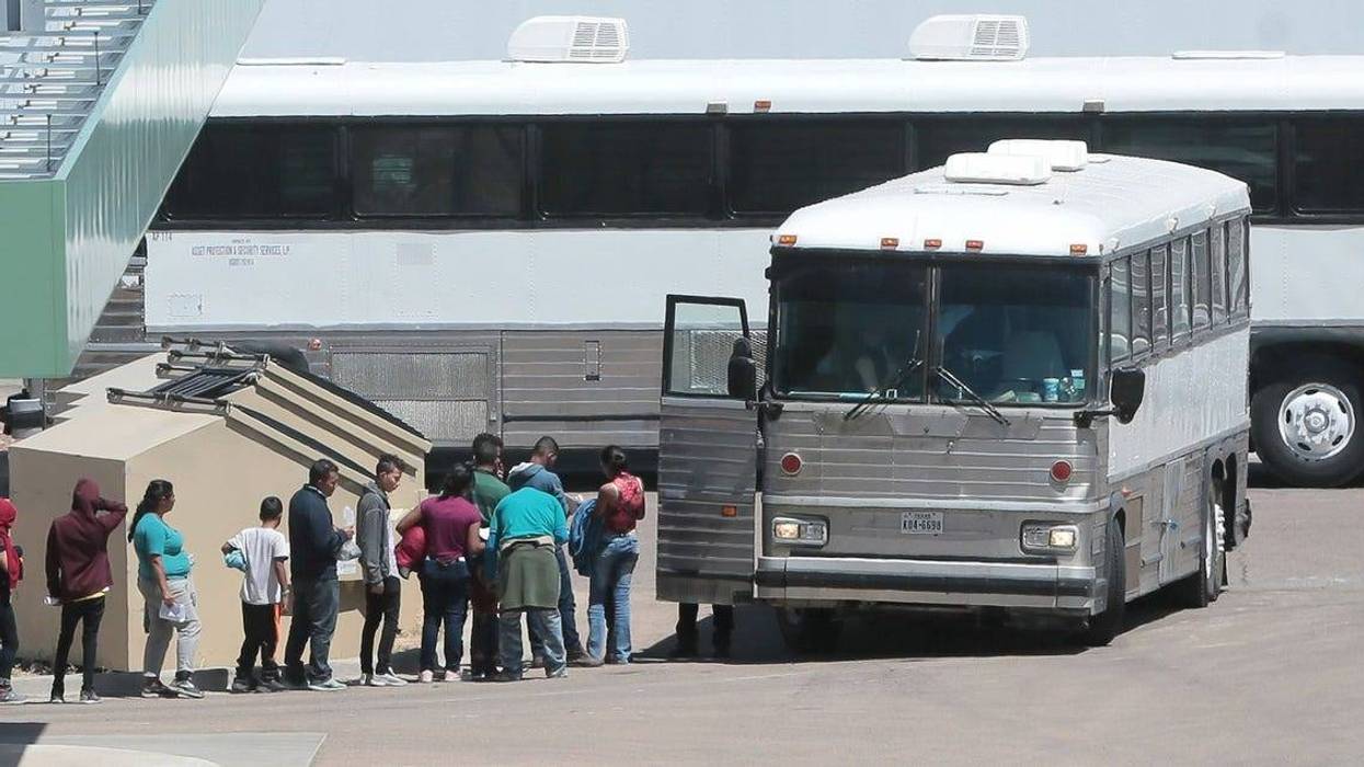 Migrants are loaded onto a bus at the Border Patrol Headquarters on Hondo Pass in El Paso