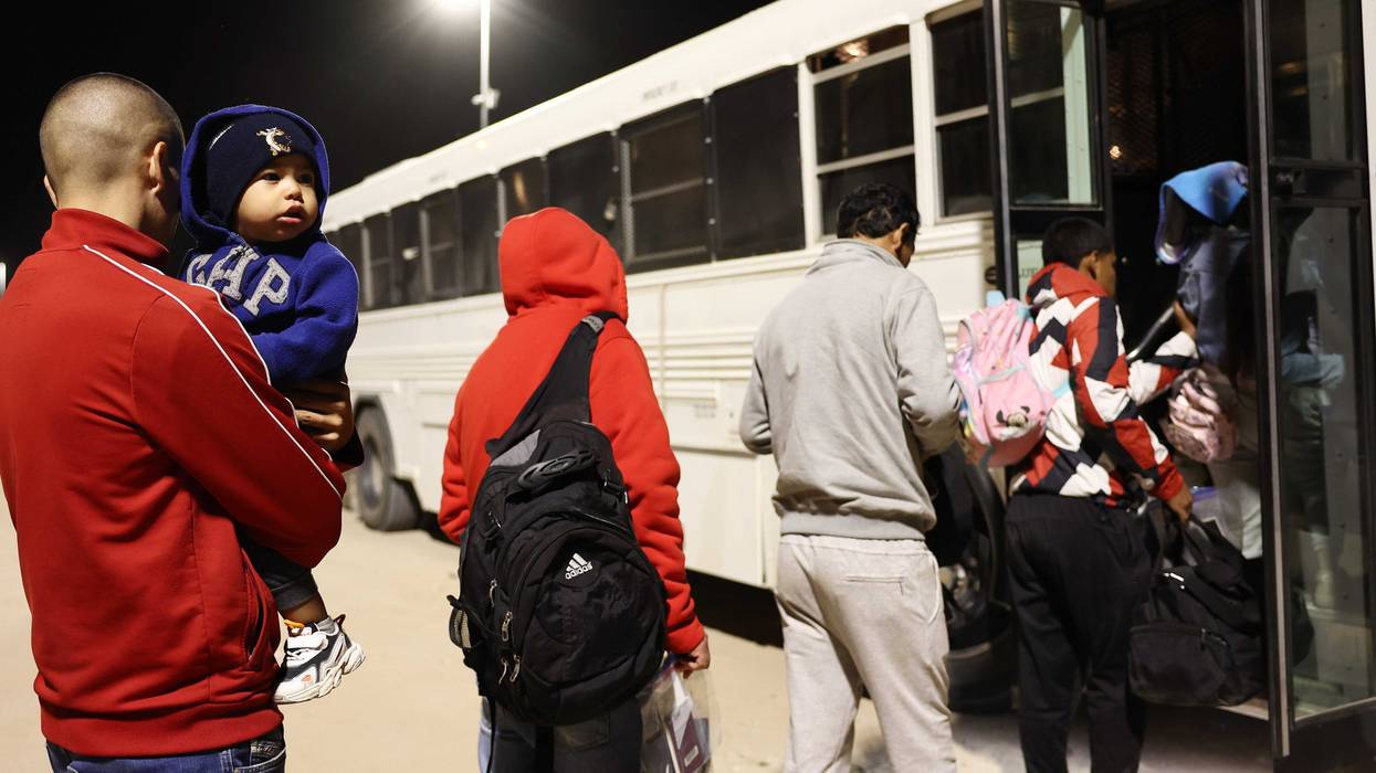 Migrants boarding a bus