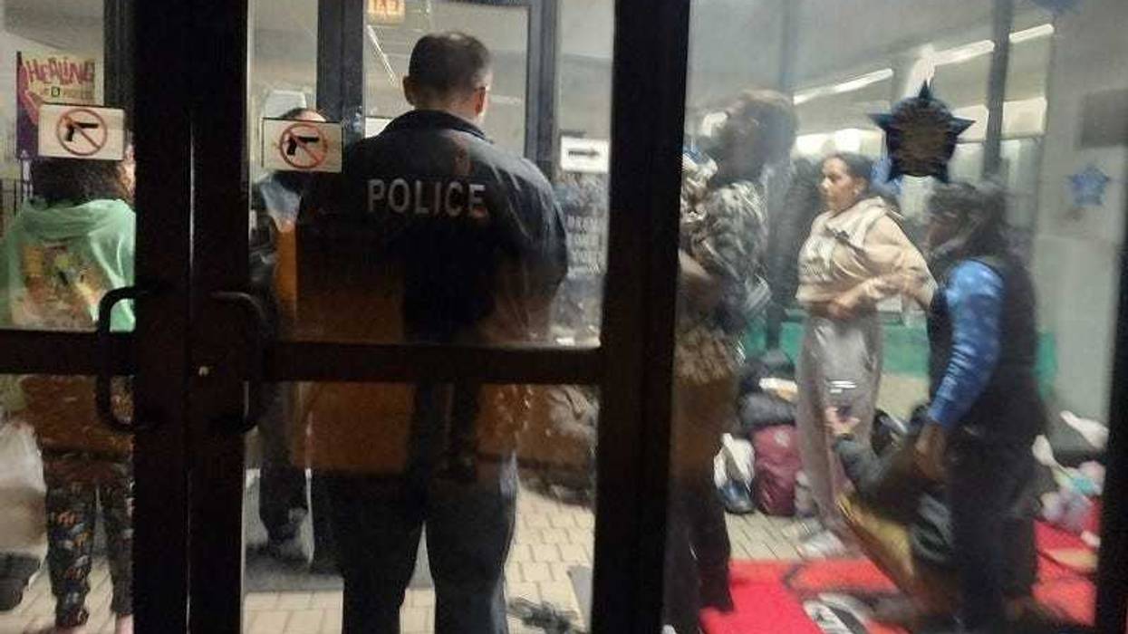Migrants in police station lobby