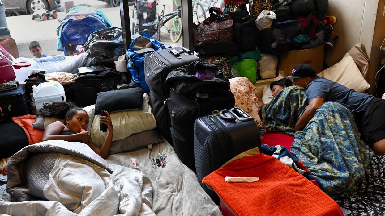 migrants laying in Chicago police station