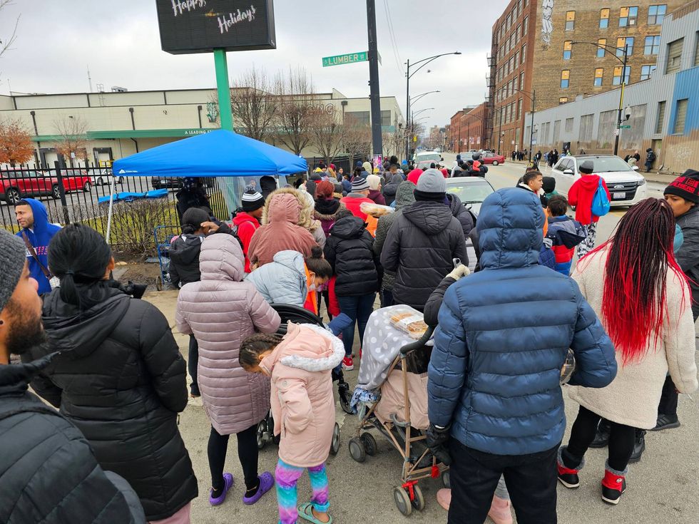 Migrants line up for a hot meal on Chicago