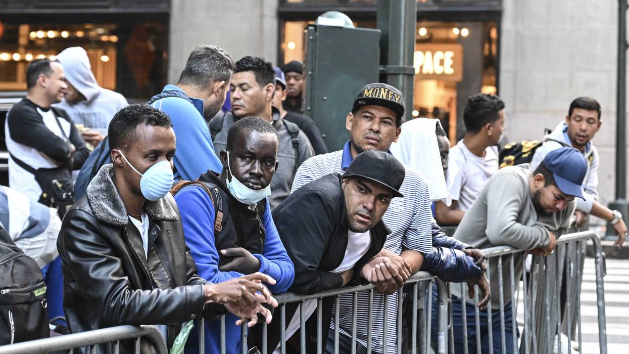 Migrants line up outside Roosevelt Hotel in Manhattan this month