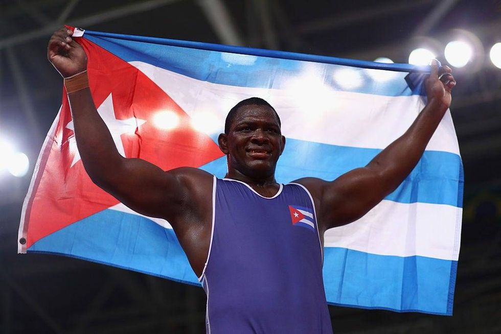 Mijain Lopez Nunez of Cuba celebrates victory over Riza Kayaalp of Turkey in the Men