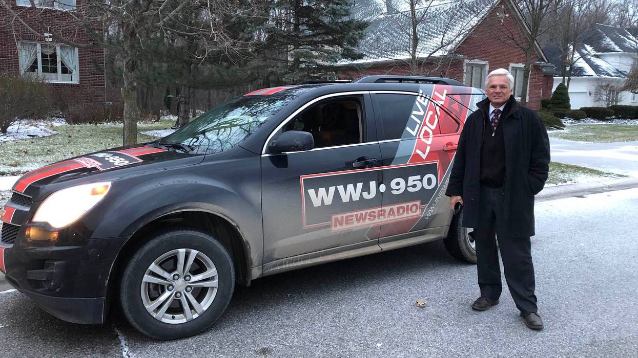 Mike Campbell is seen standing by his news car