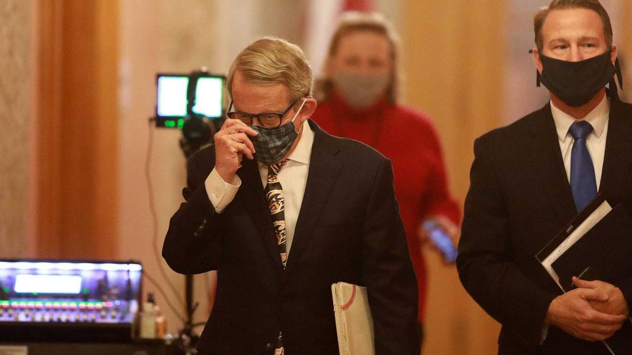 Mike DeWine (left) and Lt. Gov. Jon Husted wear their masks while walking into the daily coronavirus news conference on Friday, April 17, 2020 at the Ohio Statehouse in Columbus, Ohio.