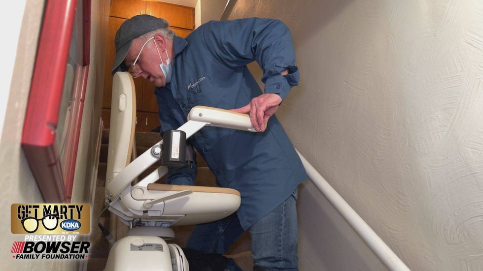 Mike Filosemi installs one of the two stairlifts for the Hairston family.