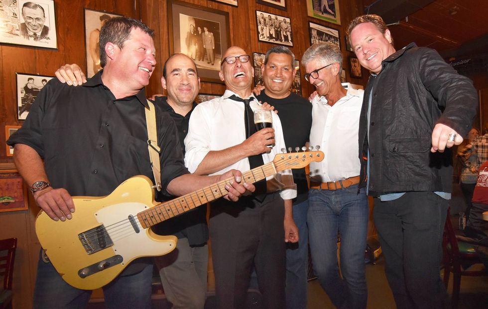 Mike laughing with his fellow bandmates of the Eyewitness Blues Band.