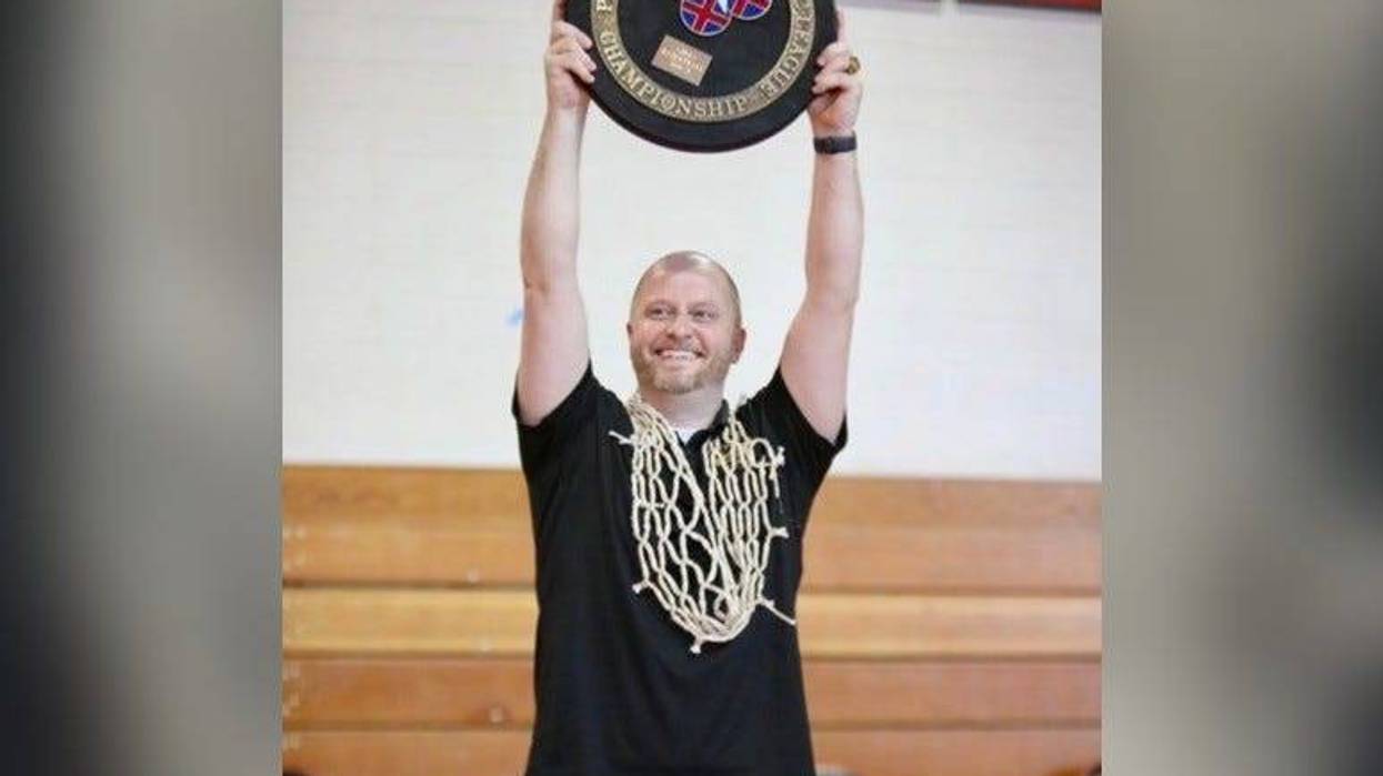 Mike McDonald holding a championship plaque.