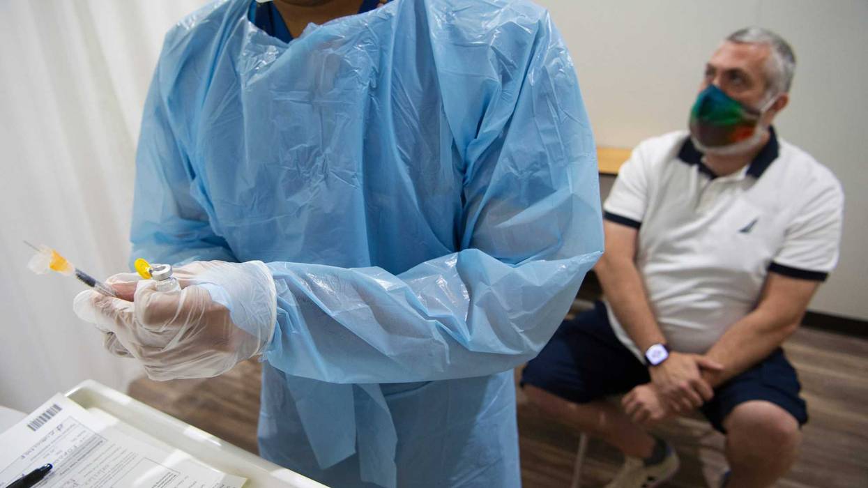 Mike Smith, of East Brunswick waits as RN Eldho Itoop draws a syringe of the Monkeypox vaccine in Paramus, N.J. on Thursday Aug. 4, 2022.