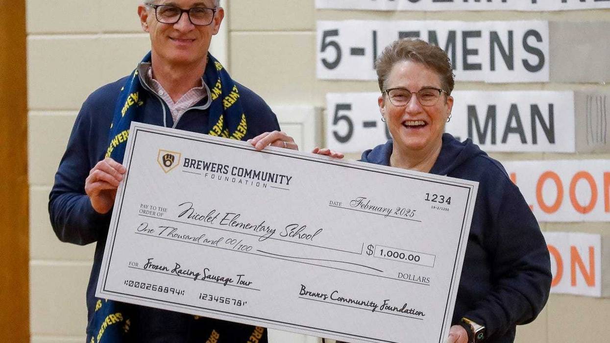Milwaukee Brewers president Rick Schlesinger presents a check for $1,000 to principal Lori McArthur on Tuesday, February 11, 2025, at Nicolet Elementary in Green Bay, Wis. The visit was part of the Brewers’ “Frozen Racing Sausage” tour, which is visiting communities across the state in February ahead of spring training. Tork Mason/USA TODAY NETWORK-Wisconsin