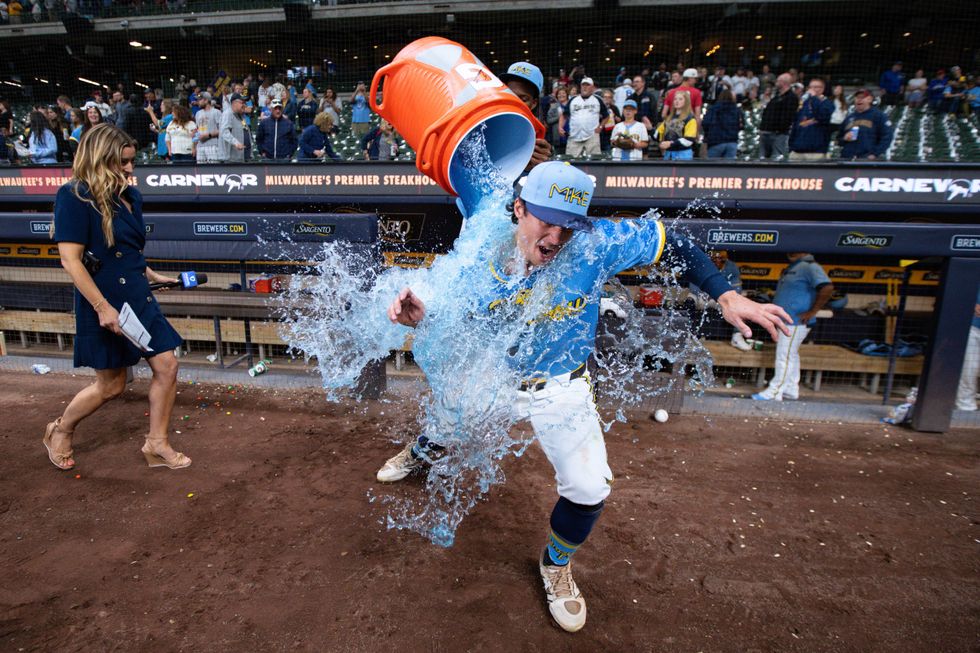 Milwaukee Brewers right fielder Sal Frelick (10) is dunked with Gatorade following the game against the St. Louis Cardinals at American Family Field.