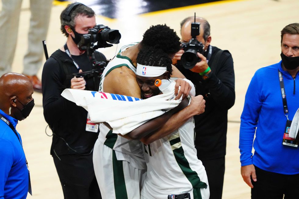 Milwaukee Bucks forward Giannis Antetokounmpo (34) and Bucks guard Jrue Holiday (21) celebrate after defeating the Phoenix Suns during game five of the 2021 NBA Finals at Phoenix Suns Arena.