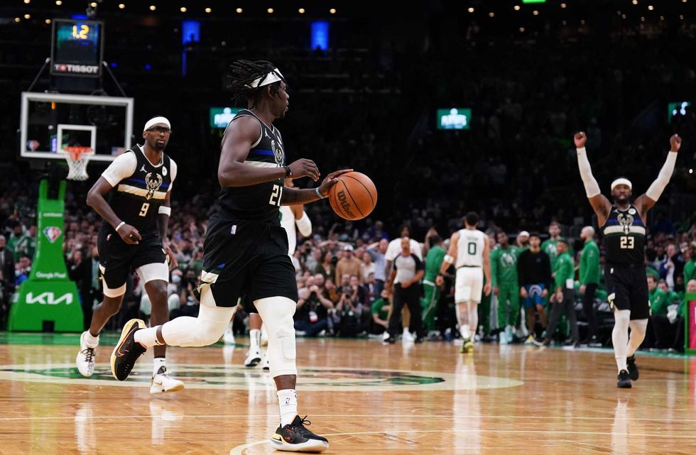 Milwaukee Bucks guard Jrue Holiday (21) steals the ball from Boston Celtics guard Marcus Smart (36) (not pictured) to end the game in the second half during game five of the second round for the 2022 NBA playoffs at TD Garden.