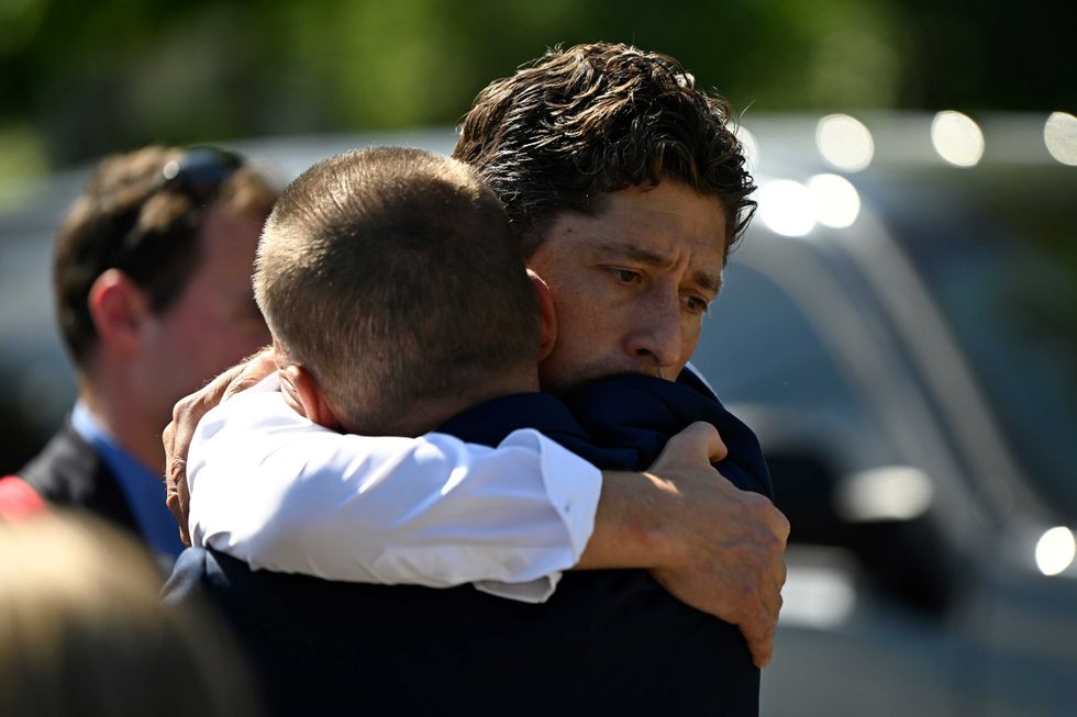 Minneapolis Mayor Jacob Frey is embraced after speaking to the media following a mass shooting at Annunciation Catholic School on August 27, 2025 in Minneapolis, Minnesota.