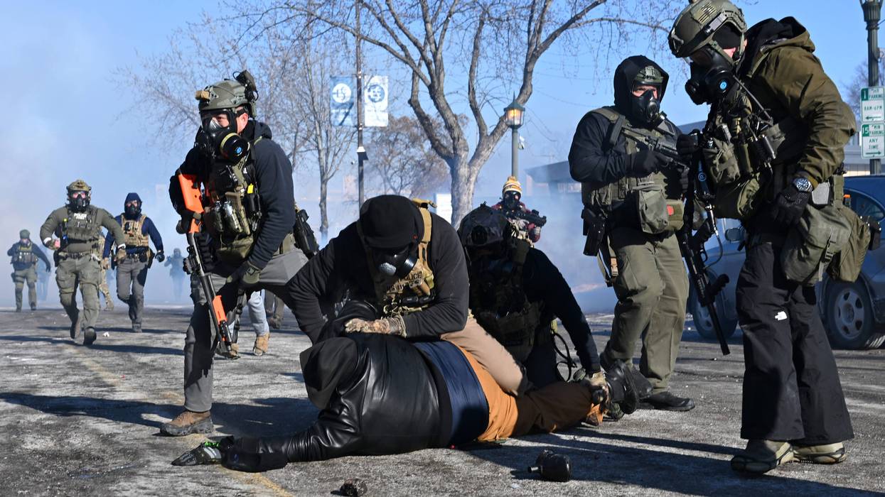 MINNEAPOLIS, MINNESOTA - JANUARY 24: A person is tackled by federalz agent amid protests following a shooting on January 24, 2026 in Minneapolis, Minnesota. Federal agents allegedly shot and killed a protestor amid a scuffle to arrest him. The Trump administration has sent a reported 3,000 federal agents into the area, with more on the way, as they make a push to arrest undocumented immigrants in the region. (Photo by Brandon Bell/Getty Images)